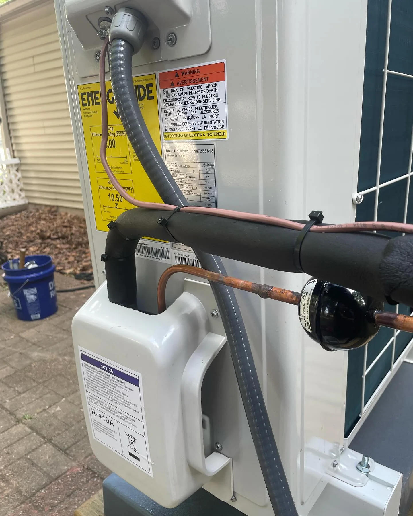Refrigerant and electrical connections on a freshly installed AC condenser in Plainfield, IN