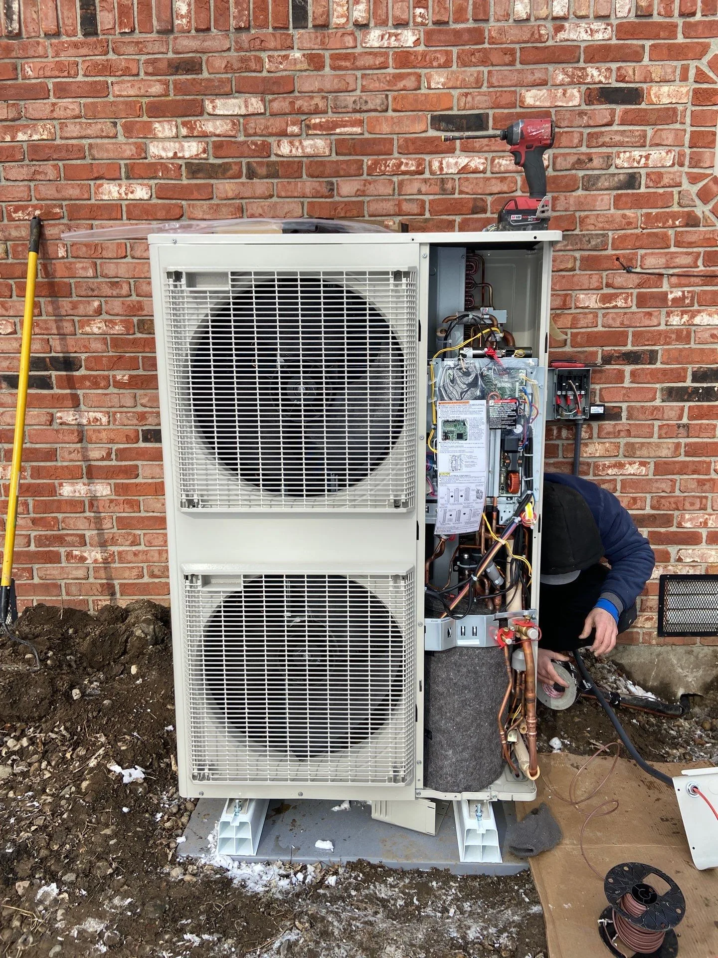 Daikin Fit condenser installed against a brick wall in Plainfield, IN