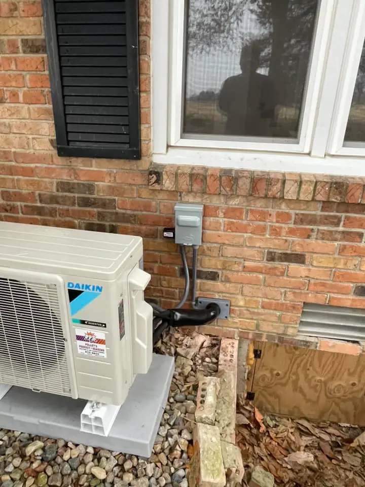 Daikin mini-split heat pump mounted on the foundation of a Plainfield, IN home