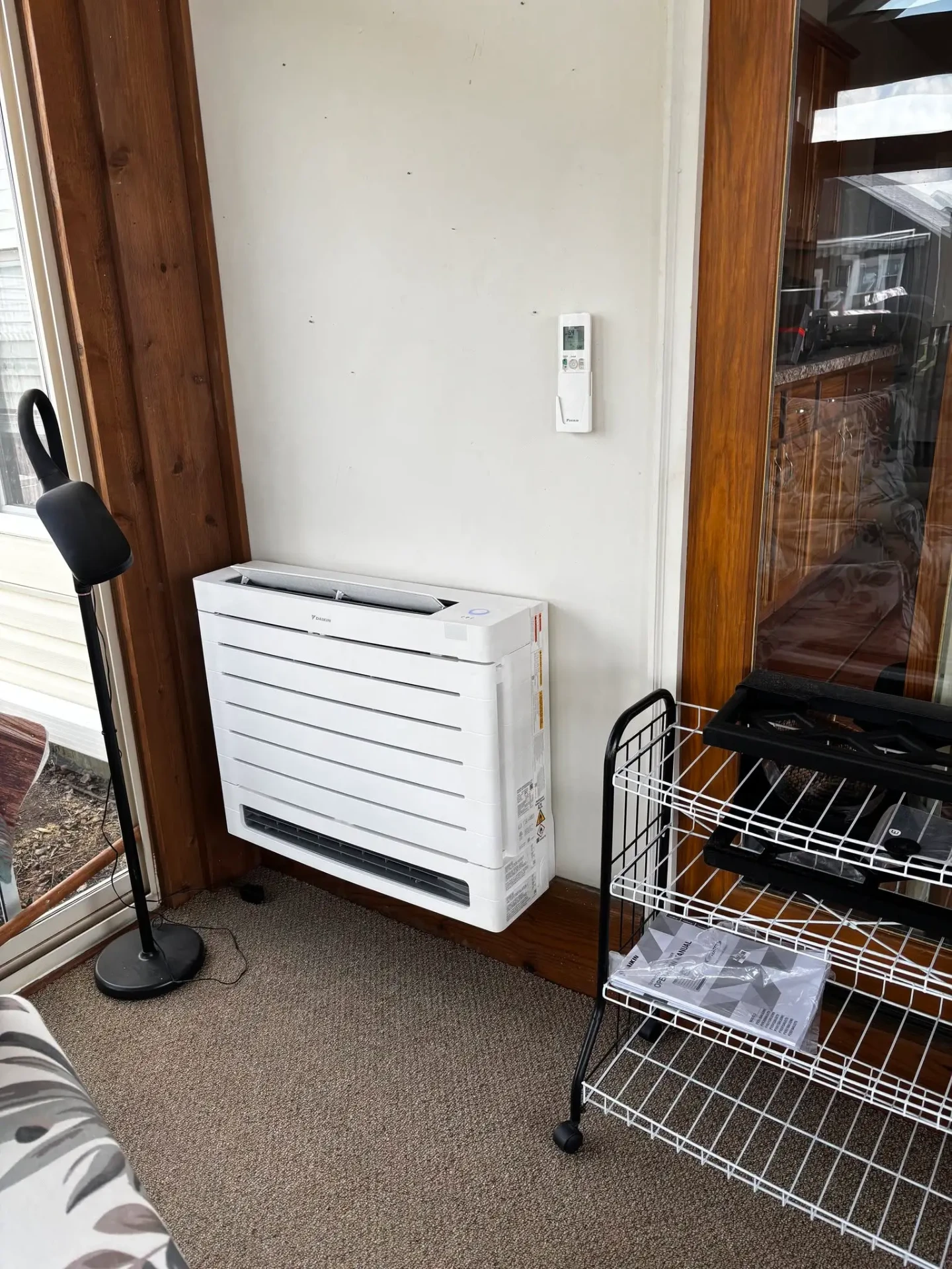 Daikin floor mounted ductless mini split unit and wall remote installed in a sunroom in Avon, Indiana