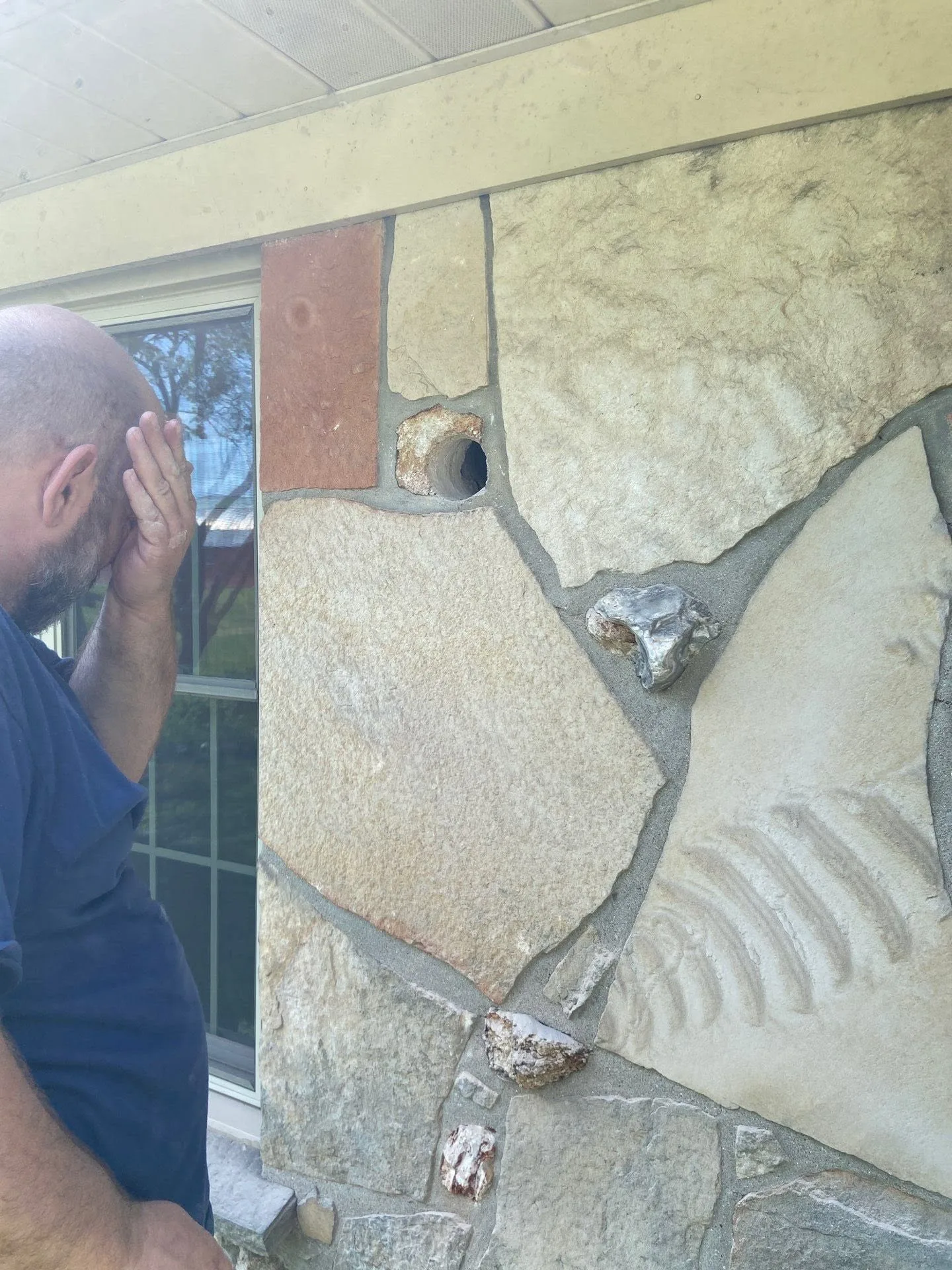 Core drilled hole through thick stone siding for a ductless mini split line set in Avon, Indiana