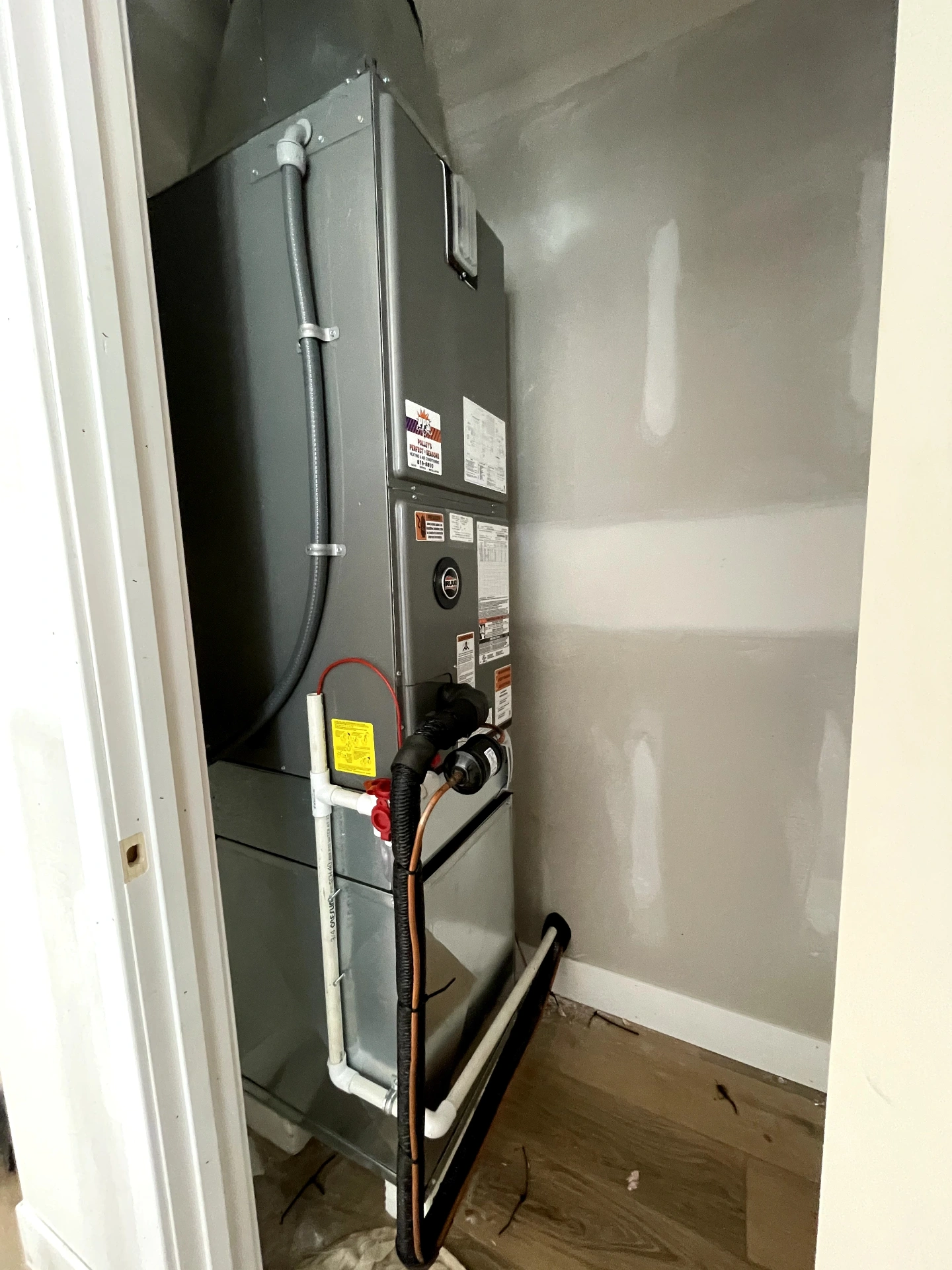 Brand-new furnace and air handler installed in a utility closet at a Camby, IN home