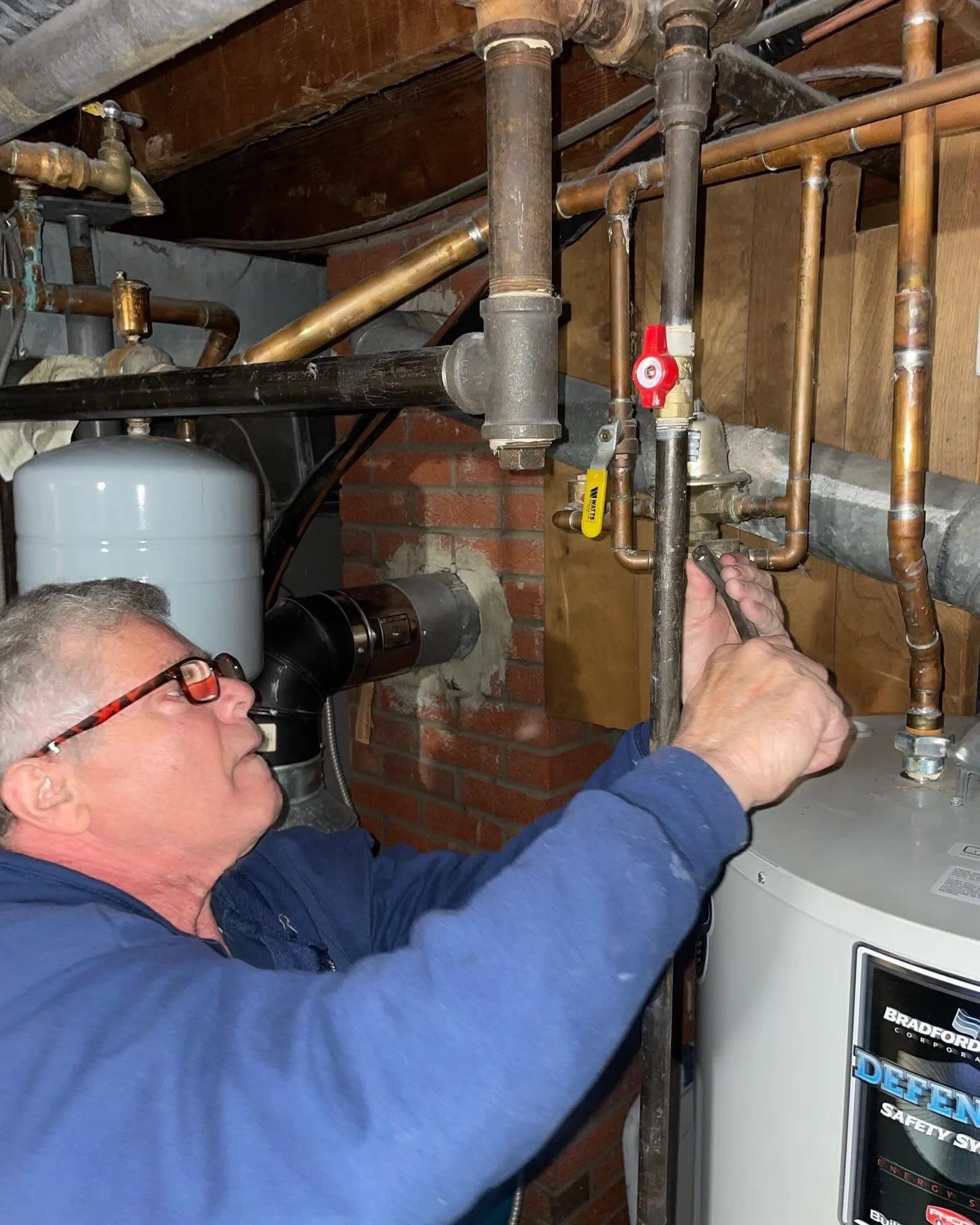 Polley's Perfect Seasons technician repairing water heater pipes in Plainfield, IN