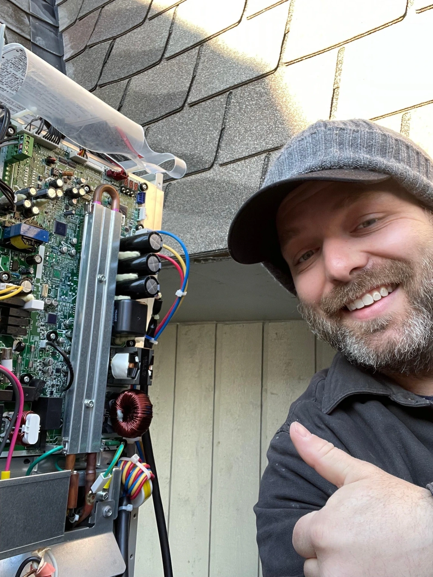 Polley's Perfect Seasons technician giving a thumbs-up after a successful heat pump control board repair in Plainfield, IN