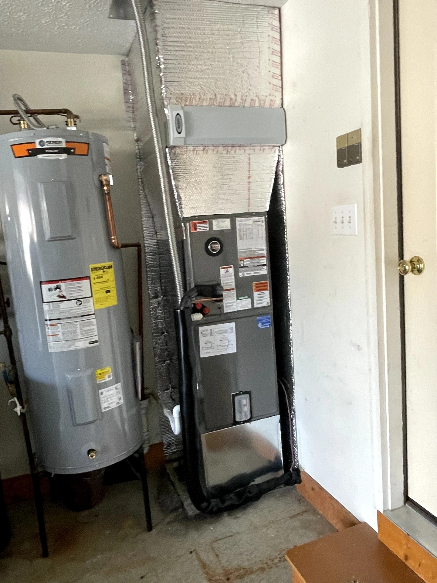 New electric water heater installed alongside a high-efficiency air handler by Polley's Perfect Seasons in Plainfield, IN
