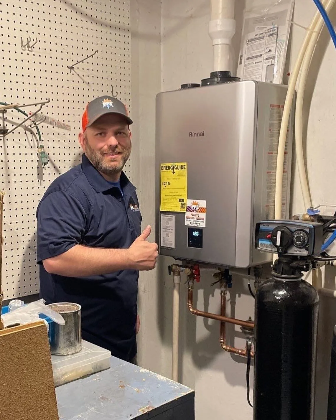 Polley's technician giving thumbs up next to a new Rinnai tankless water heater